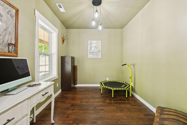 interior space featuring visible vents, dark wood-style floors, and baseboards