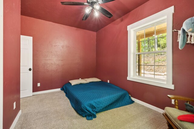 bedroom featuring baseboards, a ceiling fan, and carpet