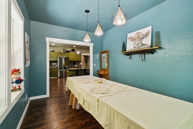 bedroom featuring vaulted ceiling, dark wood-style flooring, freestanding refrigerator, and baseboards