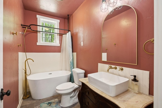 full bathroom with a freestanding tub, a shower with shower curtain, toilet, and vanity