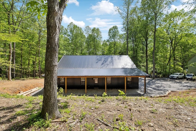 exterior space featuring a forest view