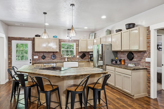 2217 Wiley Pardue Rd, Ashland City, TN 37015 - kitchen featuring stainless steel fridge with ice dispenser, a kitchen bar, decorative backsplash, dark wood-type flooring, and decorative light fixtures
