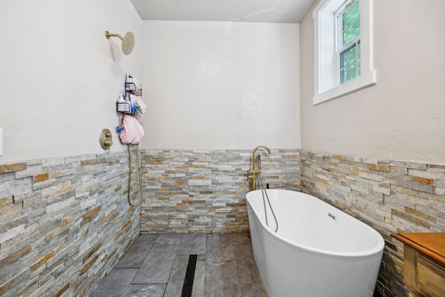 2217 Wiley Pardue Rd, Ashland City, TN 37015 - full bath with a freestanding bath, wainscoting, and stone finish floors