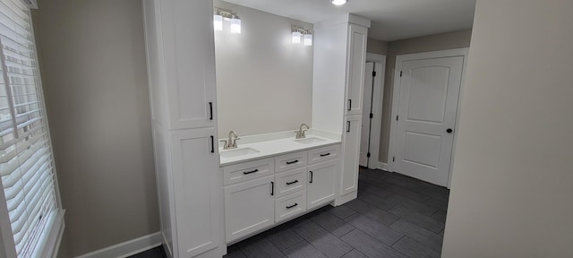 bathroom featuring recessed lighting, a wealth of natural light, and a sink