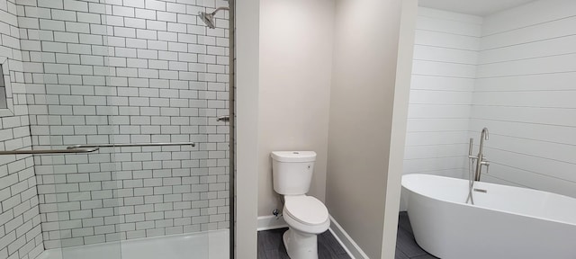 full bath featuring toilet, a shower stall, baseboards, and a soaking tub