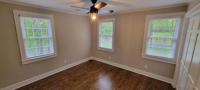 spare room with a wealth of natural light, dark wood-style flooring, and baseboards