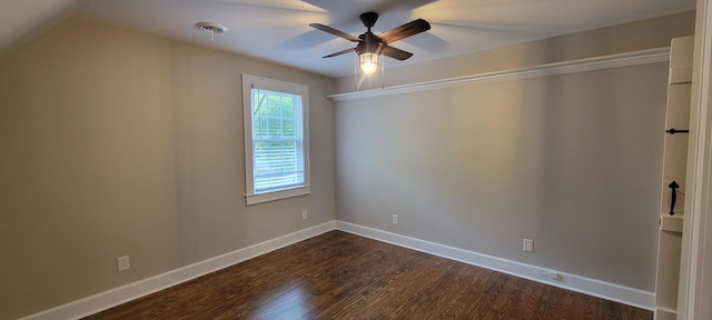 spare room featuring ceiling fan, visible vents, dark wood-style floors, and baseboards