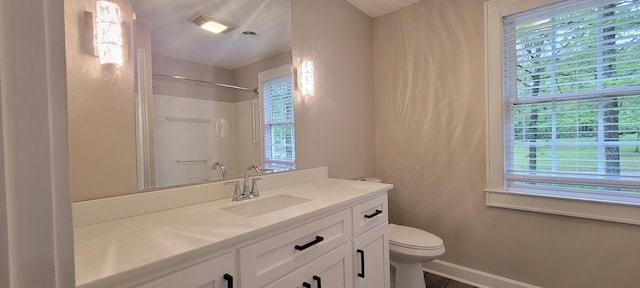 bathroom with visible vents, baseboards, walk in shower, toilet, and vanity
