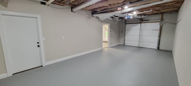 garage with baseboards and a garage door opener