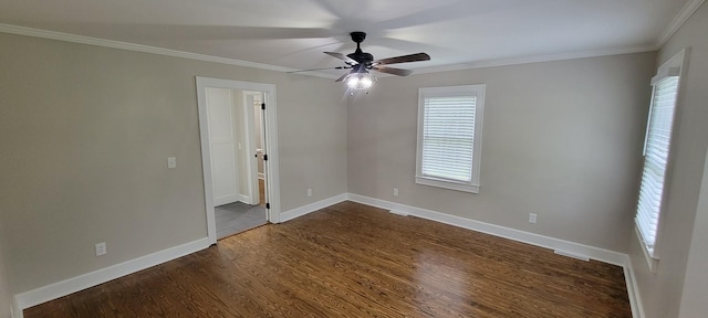 unfurnished room featuring a ceiling fan, crown molding, and dark wood-style floors