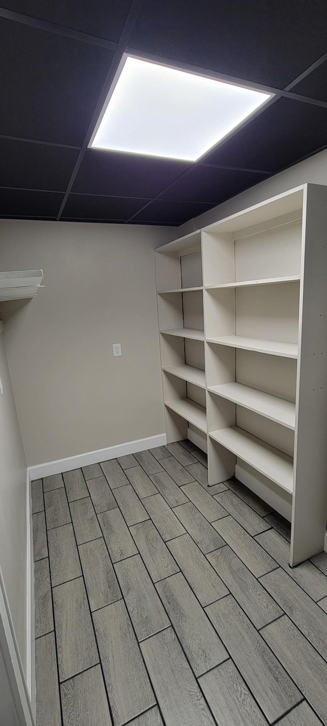 finished basement featuring wood finished floors and baseboards
