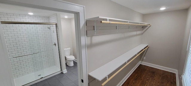 spacious closet with dark wood finished floors