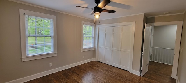unfurnished bedroom featuring dark wood finished floors, a closet, ornamental molding, ceiling fan, and baseboards