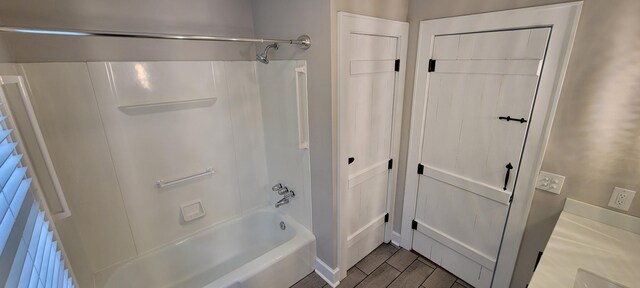 bathroom with wood finished floors and shower / washtub combination