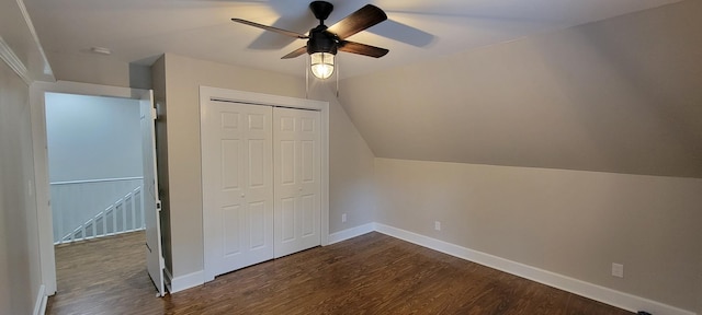 additional living space with dark wood-style floors, a ceiling fan, vaulted ceiling, and baseboards