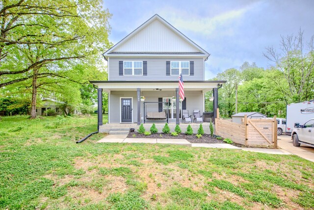 traditional-style home with covered porch and a front lawn