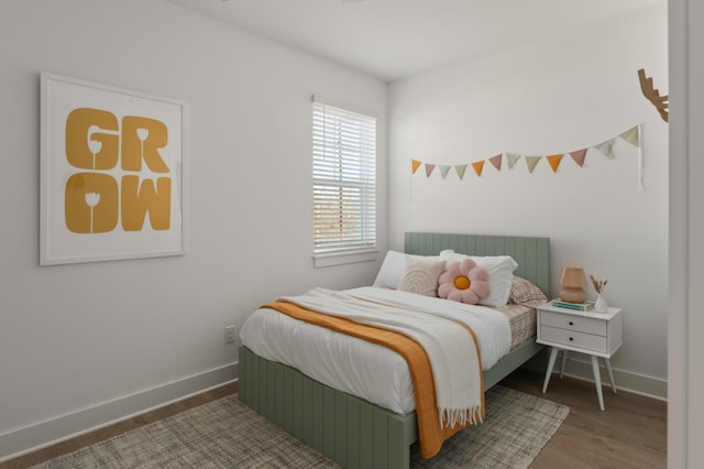 bedroom featuring wood finished floors and baseboards