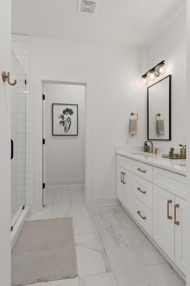 bathroom with marble finish floor, vanity, baseboards, visible vents, and a stall shower