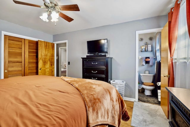 bedroom featuring light wood-style flooring, connected bathroom, baseboards, and a ceiling fan
