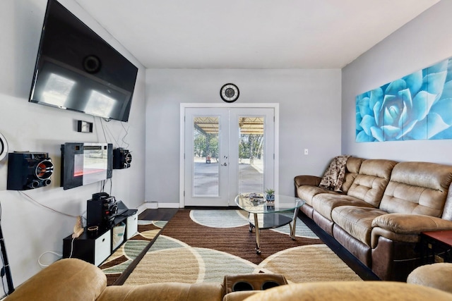 living room with wood finished floors, french doors, and baseboards