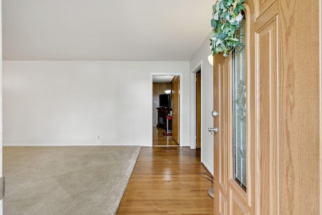 entryway with light wood finished floors and baseboards