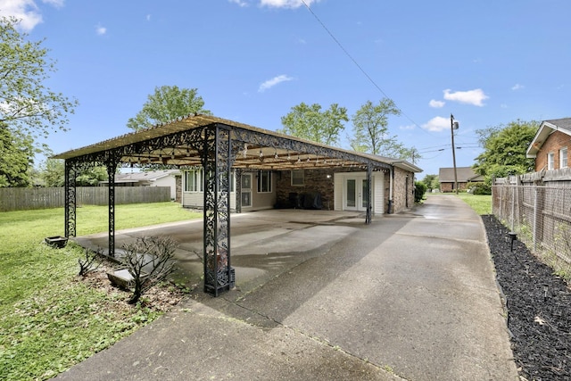 view of patio with french doors, a carport, and driveway