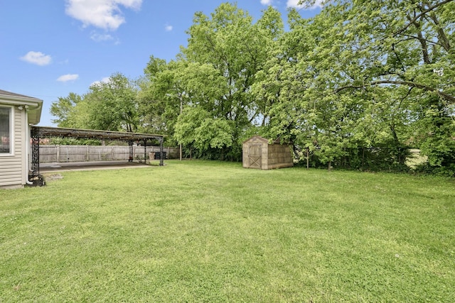 view of yard with a shed, an outbuilding, and a patio