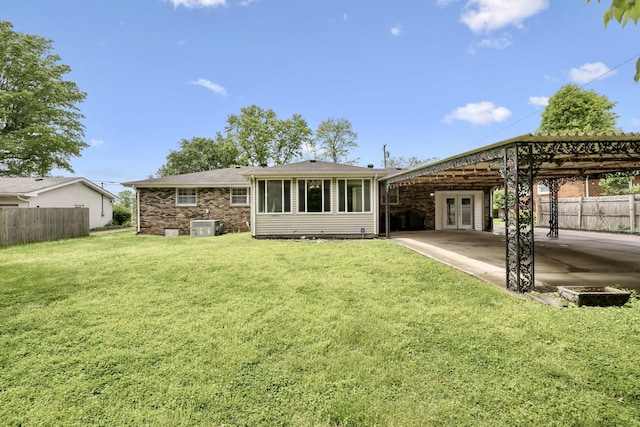 rear view of house with french doors and a patio