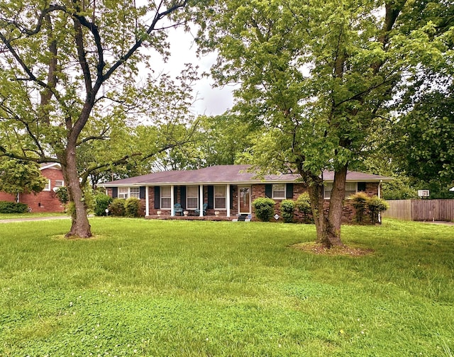 ranch-style home with a porch and brick siding