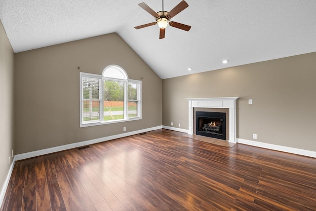 2938 Heatherfield Dr, Woodlawn, TN 37191 - unfurnished living room featuring a ceiling fan, dark wood-style floors, vaulted ceiling, a fireplace with flush hearth, and baseboards