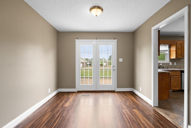 2938 Heatherfield Dr, Woodlawn, TN 37191 - doorway featuring dark wood-type flooring, baseboards, and a textured ceiling