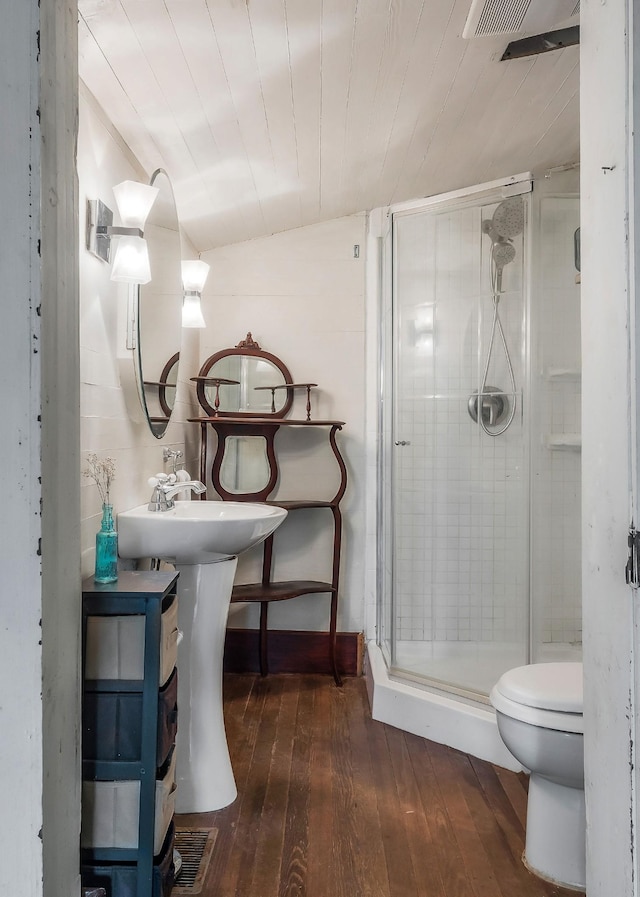 bathroom with toilet, a shower stall, hardwood / wood-style flooring, and wooden ceiling