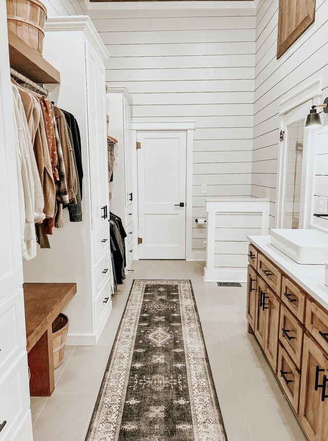 233 Garner Ln, Lawrenceburg, TN 38464 - mudroom featuring light tile patterned floors, wooden walls, and visible vents