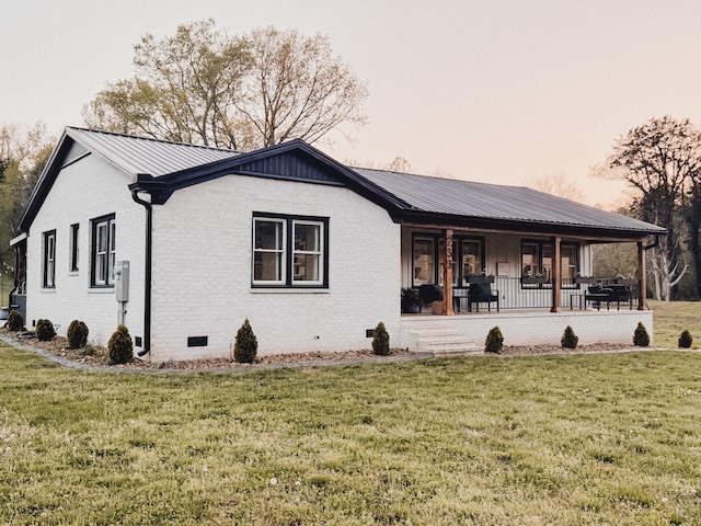 233 Garner Ln, Lawrenceburg, TN 38464 - view of property exterior with metal roof, a lawn, and brick siding