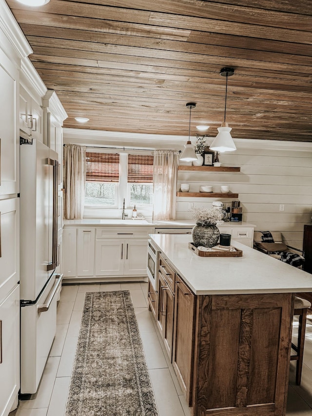 233 Garner Ln, Lawrenceburg, TN 38464 - kitchen with a sink, wooden ceiling, a center island, white cabinets, and freestanding refrigerator
