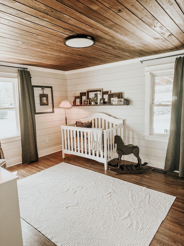 233 Garner Ln, Lawrenceburg, TN 38464 - bedroom with visible vents, wood finished floors, wooden walls, and wood ceiling