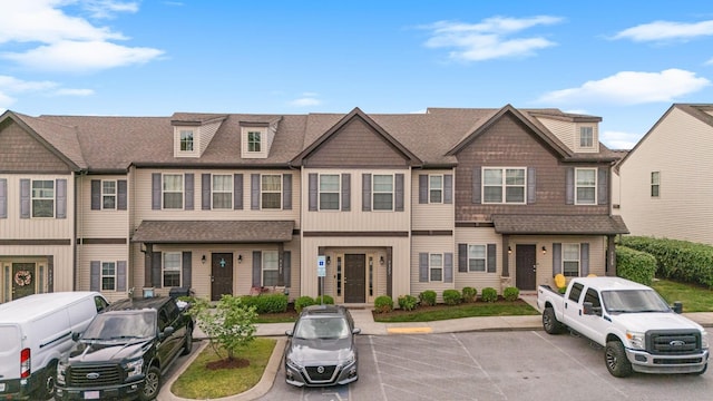 townhome / multi-family property featuring uncovered parking