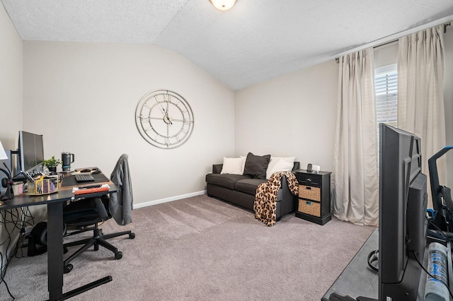 carpeted office featuring a textured ceiling, vaulted ceiling, and baseboards