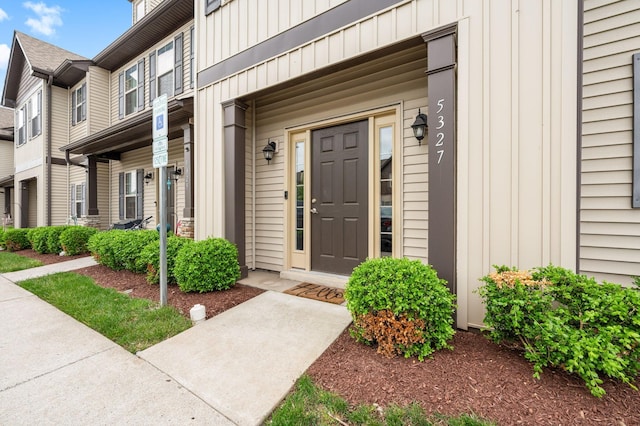 entrance to property featuring a porch and board and batten siding