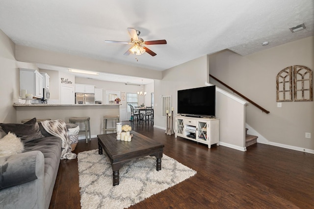 living room featuring a ceiling fan, stairs, wood finished floors, and baseboards