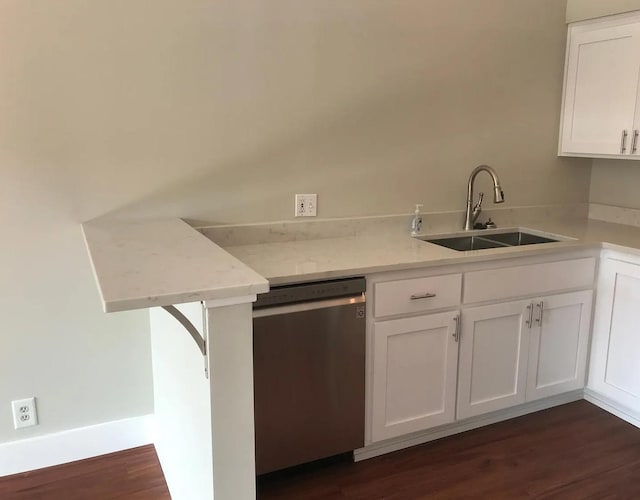 kitchen featuring dark wood-type flooring, white cabinetry, stainless steel dishwasher, and a sink