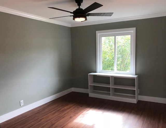 unfurnished room featuring a ceiling fan, ornamental molding, dark wood finished floors, and baseboards