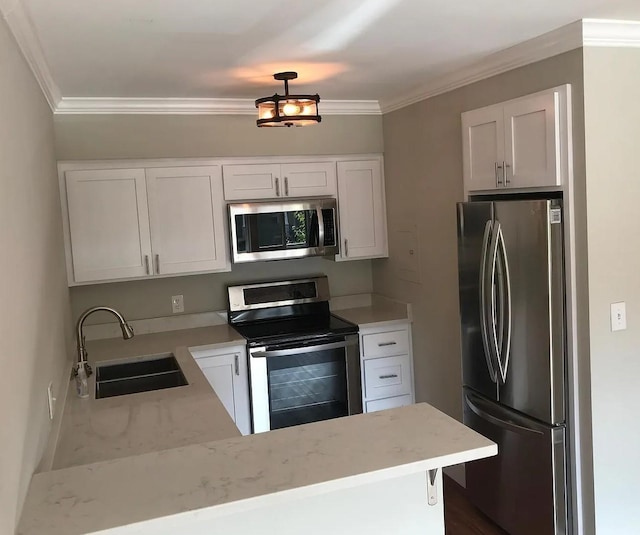 kitchen featuring a sink, appliances with stainless steel finishes, and white cabinetry