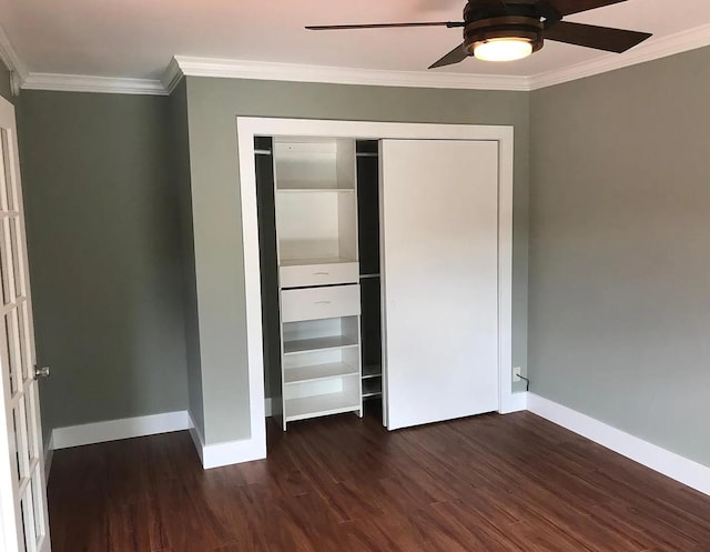 unfurnished bedroom featuring ornamental molding, dark wood-style flooring, and baseboards