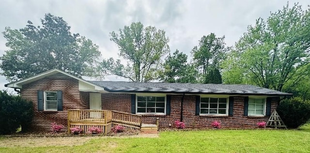 view of front of home featuring a front yard and brick siding
