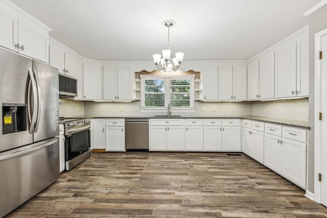 kitchen featuring white cabinetry, open shelves, a sink, appliances with stainless steel finishes, and a chandelier