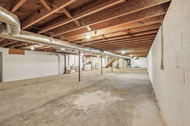 unfinished basement with concrete block wall