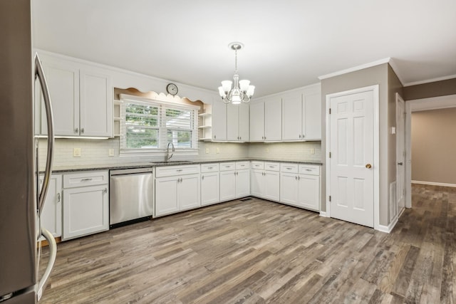 kitchen with a sink, a notable chandelier, open shelves, white cabinets, and appliances with stainless steel finishes