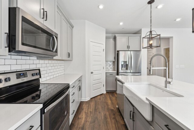 3227 Brookberry Ln, Murfreesboro, TN 37129 - kitchen with stainless steel appliances, gray cabinetry, light countertops, tasteful backsplash, and recessed lighting