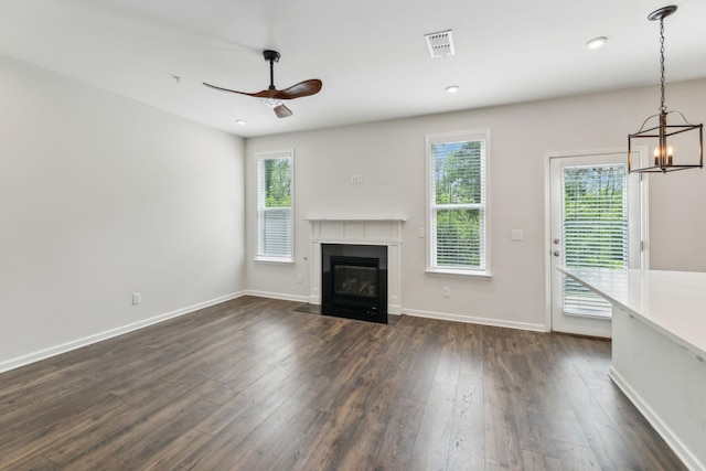 3227 Brookberry Ln, Murfreesboro, TN 37129 - unfurnished living room featuring dark wood-type flooring, ceiling fan, a fireplace with flush hearth, a chandelier, and baseboards